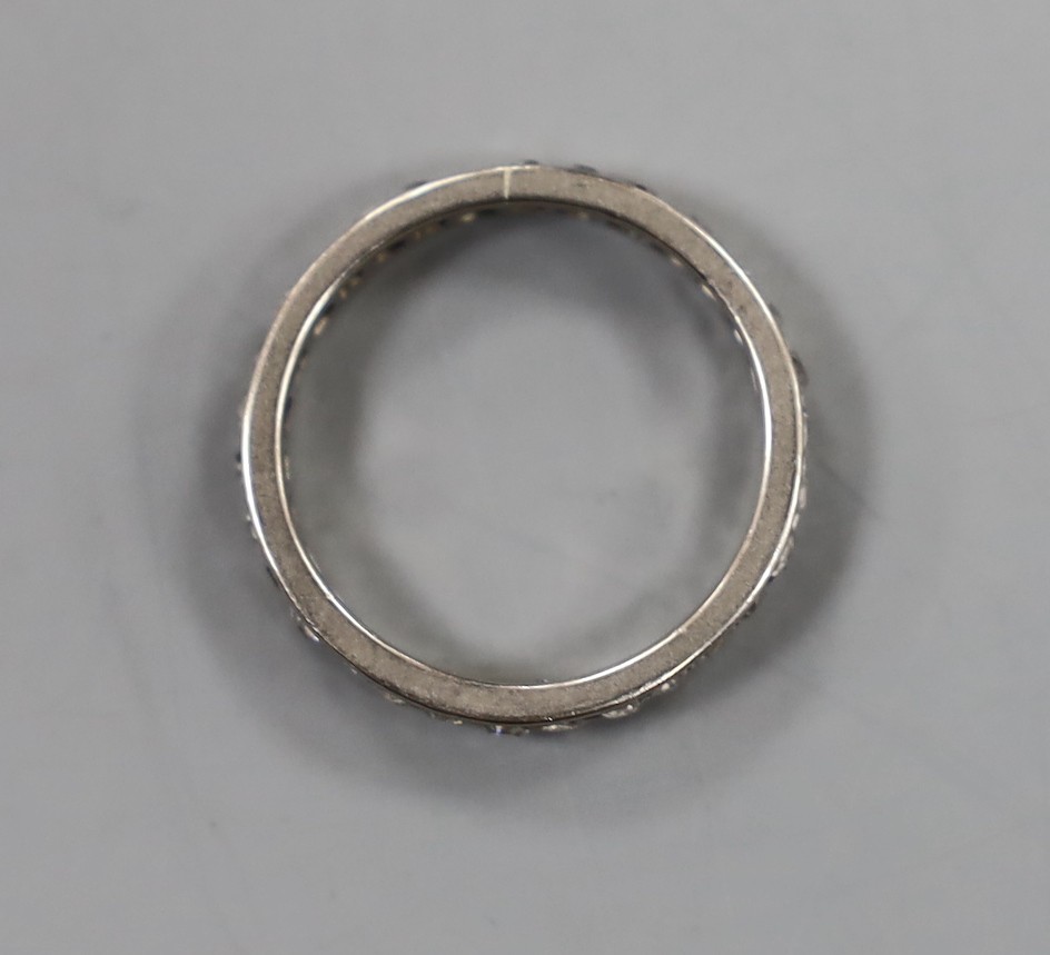 A white metal and diamond set full eternity ring, M/N, gross weight 2.7 grams.